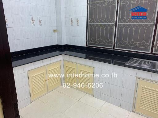 Kitchen with tiled walls and countertop