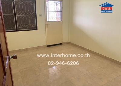 Empty room with tiled floor and a door leading outside