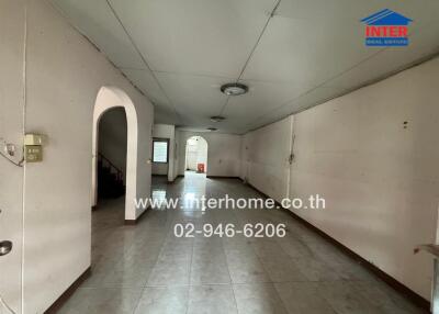 Spacious main living area with tiled floors and ceiling lights