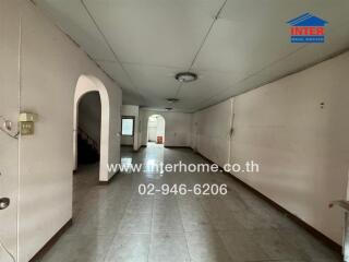 Spacious main living area with tiled floors and ceiling lights