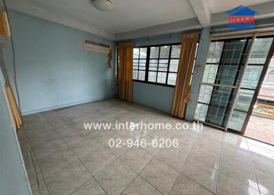 Spacious living room with tiled flooring and large windows