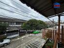 View of balcony overlooking street and neighboring houses