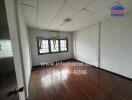 Unfurnished bedroom with wooden floors and large windows