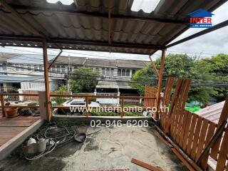 Outdoor terrace with partial roofing and garden view