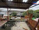 Outdoor terrace with partial roofing and garden view