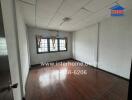 Bedroom with wooden flooring and curtains on windows