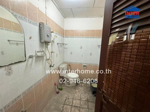 Bathroom with shower area and toilet