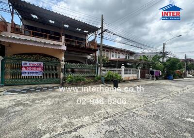 Facade of a residential building with a gated yard