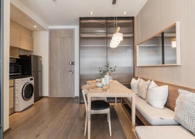 Modern dining area with built-in seating and adjacent laundry appliances