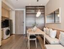 Modern dining area with built-in seating and adjacent laundry appliances