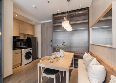 Modern dining area with integrated kitchen and laundry appliances