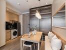 Modern dining area with integrated kitchen and laundry appliances