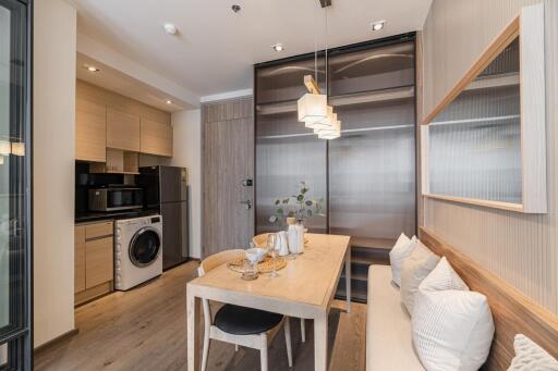 Modern dining area with integrated kitchen and laundry appliances