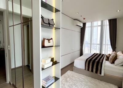 Modern bedroom with stylish bookshelf and large windows