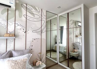 Modern bedroom with mirrored closets and decorative wall art