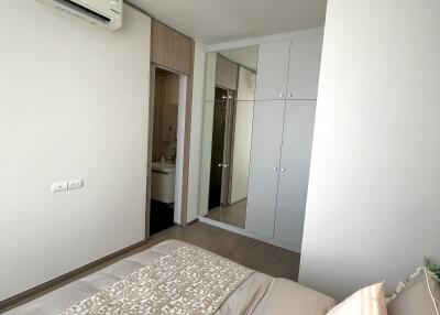 Modern bedroom with air conditioning, closet, and view of bathroom