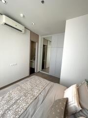 Modern bedroom with air conditioning, closet, and view of bathroom