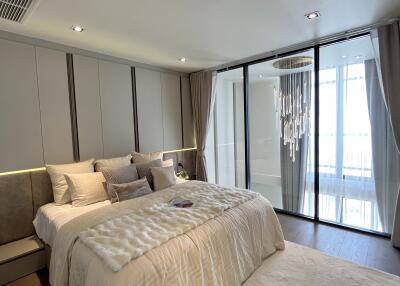 Modern bedroom with large window and chandelier