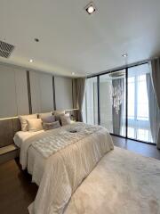 Modern bedroom with large window and chandelier