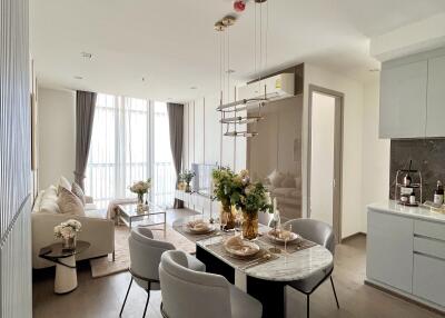 Elegant dining area connected to a cozy living room with large windows