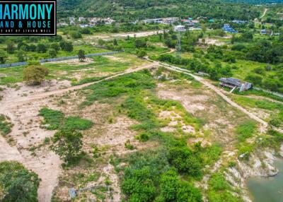 Aerial view of a vast plot of land with surrounding greenery