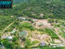 Aerial view of a property area with greenery, ponds, and multiple structures