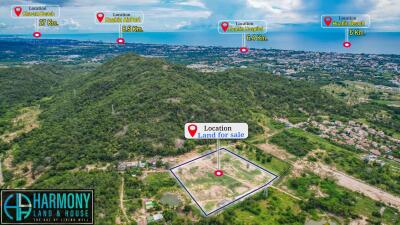 Aerial view of land for sale with multiple location markers indicating distances to nearby places