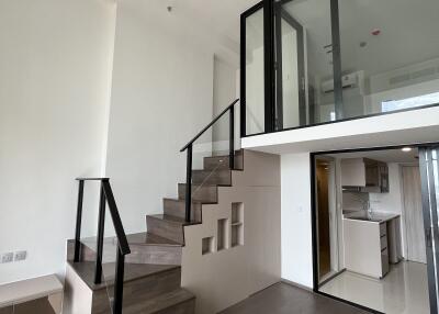 Modern duplex with kitchen and staircase to upper level