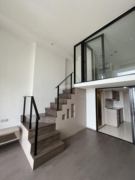 Modern duplex with kitchen and staircase to upper level