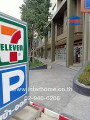 Commercial building with 7-Eleven and parking sign