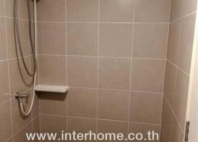 Bathroom with tiled walls and shower area