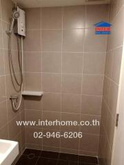 Bathroom with tiled walls and shower area