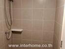 Bathroom with tiled walls and shower area