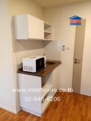 Compact kitchen with microwave and storage cabinets