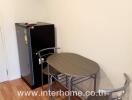 Small dining area with table, chairs, and mini refrigerator in a kitchen