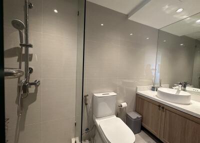 Modern bathroom with shower, toilet, and sink