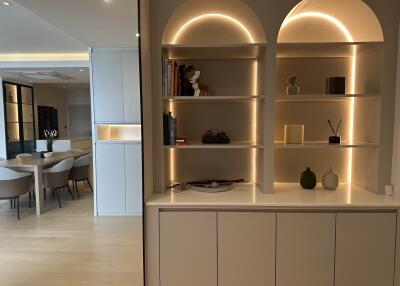 Modern living space with built-in shelves and dining area