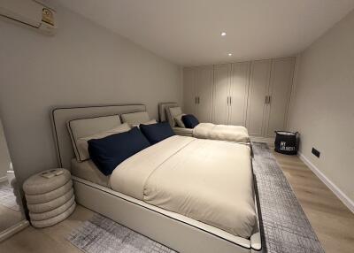 Modern bedroom with double beds and built-in wardrobes