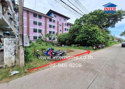 Apartment building with greenery and parked motorcycles