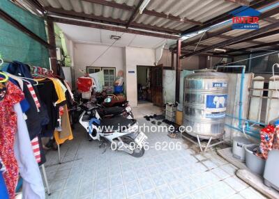 Utility area with motorbike and water storage