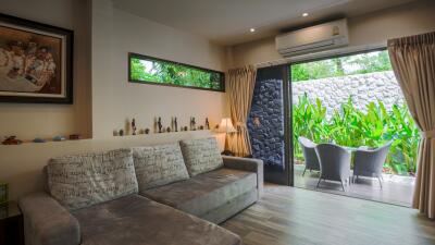 Comfortable living room with garden view through large glass doors