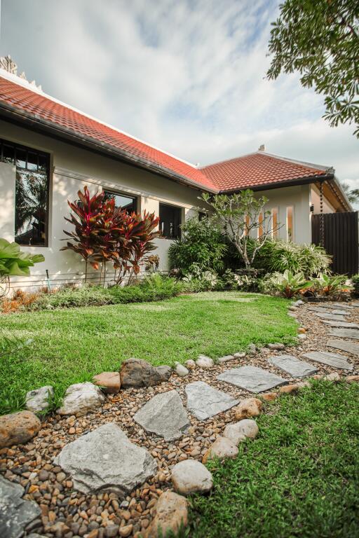 Well-maintained house exterior with garden