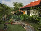 Lush garden with a stone path leading to a house