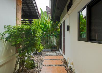 Outdoor pathway with greenery and tile steps