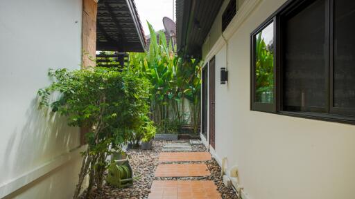 Outdoor pathway with greenery and tile steps