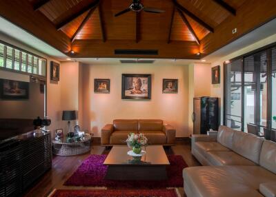 Spacious living room with modern furnishings and wooden ceiling