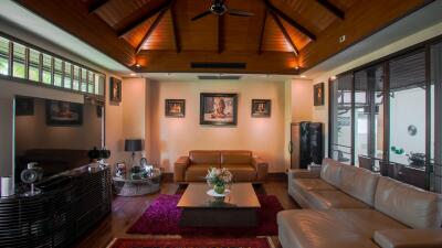 Spacious living room with modern furnishings and wooden ceiling