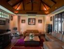 Spacious living room with modern furnishings and wooden ceiling