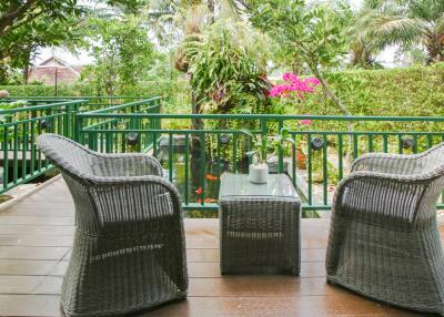 Outdoor patio with wicker furniture and garden view