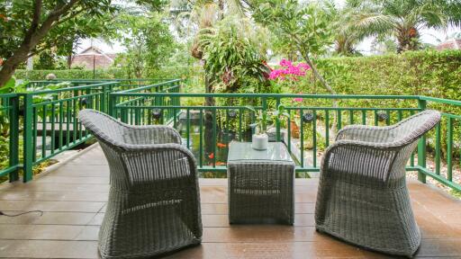 Outdoor patio with wicker furniture and garden view